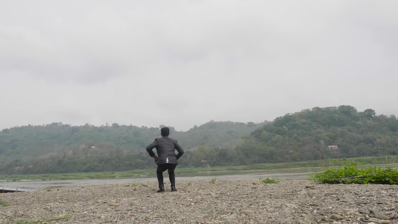 Businessman Celebrating Success by a River