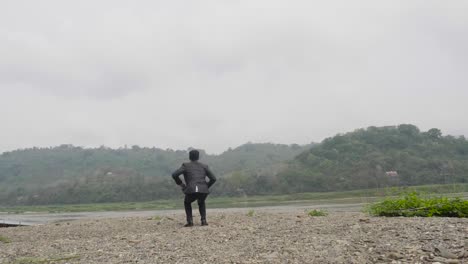 businessman celebrating success by a river