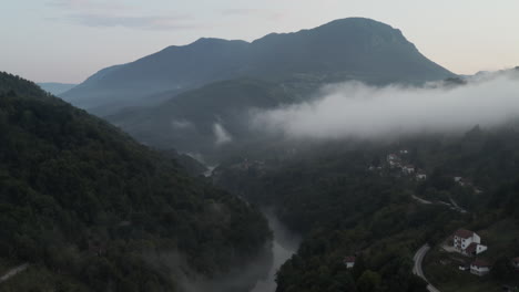 fly over river stream and spooky mountain in the balkans