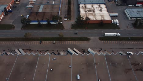 side aerial shot of the semi-truck among warehouses