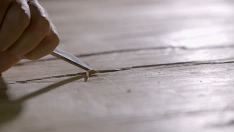 carpenter sharp wood chisel carves grooves, joinery project close up