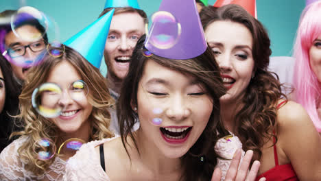 multi racial group of happy people dancing with bubbles slow motion party photo booth