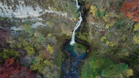 aerial-shot-of-the-gorges-du-flumen-waterfall-in-Jura-departement,-Bourgogne-Franche-Comte-region,-french-countryside-on-a-clear-day-of-autum