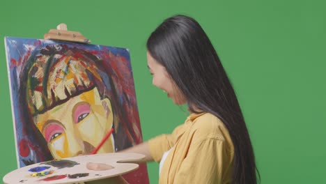 woman painting a portrait