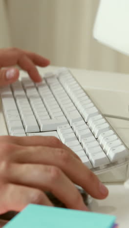 man writing with keyboard in his computer