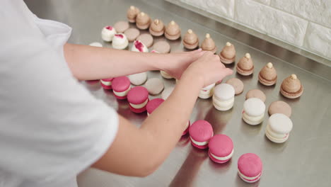 woman arranging macarons