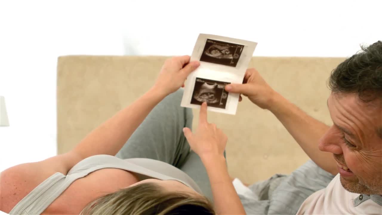 Future parents looking at sonogram