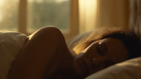 woman resting in bed with morning light