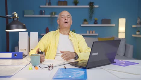 home office worker sprays perfume on old man.