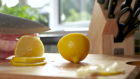 Slow-motion-shot-of-a-lemon-being-sliced