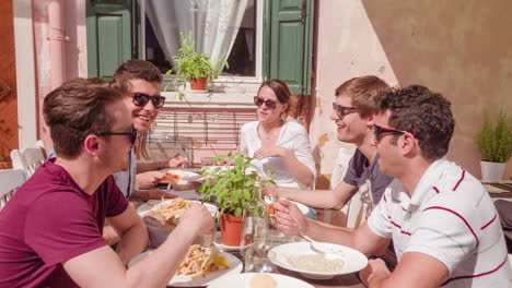 friends enjoying a meal outdoors in a cafe