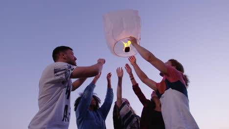 friends releasing sky lanterns into