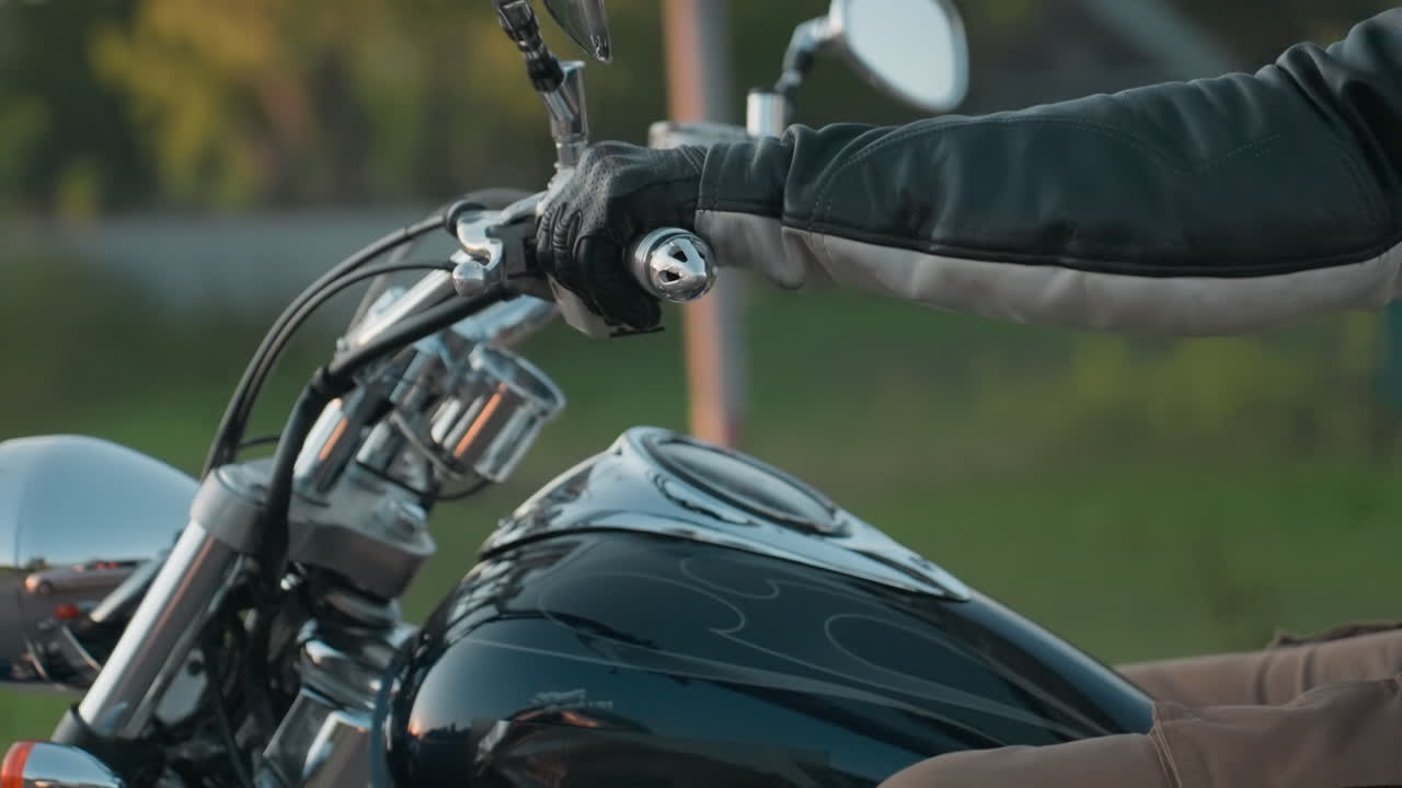 Close up of motorcycle rider and passenger embracing mid-journey, dressed in leather gear during road adventure with blurred green background