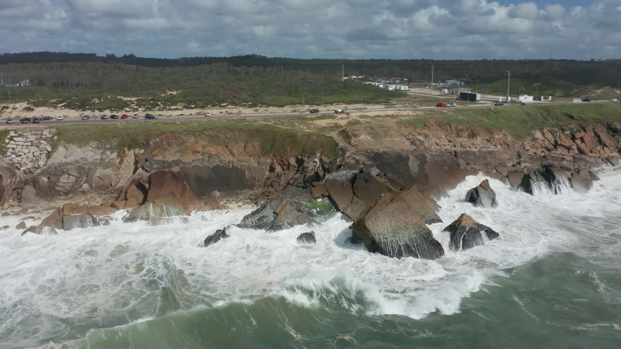 Aerial orbit of heavy waves slamming on cliffs