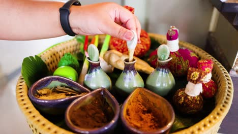 hand selecting oils and herbs for spa treatment