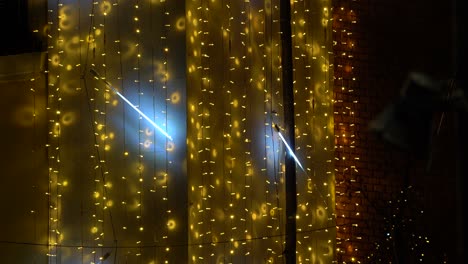 decorative flashing lights on building wall background, copy space of yellow and neon spots