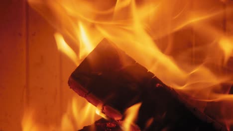 burning flame at fireplace on wooden logs