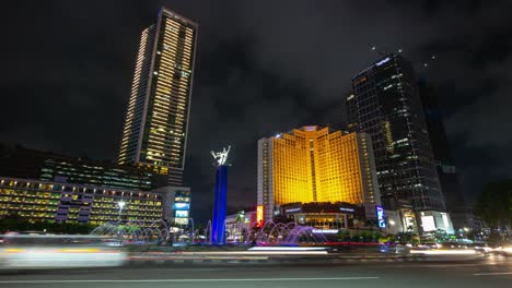 night illuminated jakarta city center famous traffic street circle fountain timelapse panorama 4k indonesia