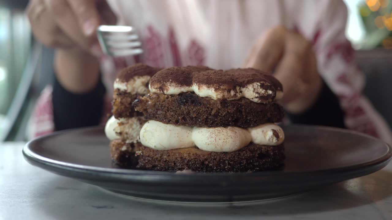 A delicious tiramisu cake being eaten