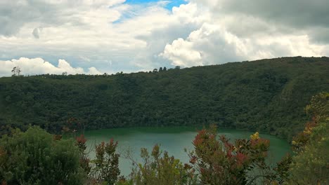scenic view of laguna de guatavita, a serene lake encircled by dense green forests