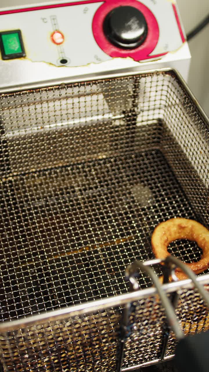 Chef Putting The Onion Rings Out Of The Frying Oil