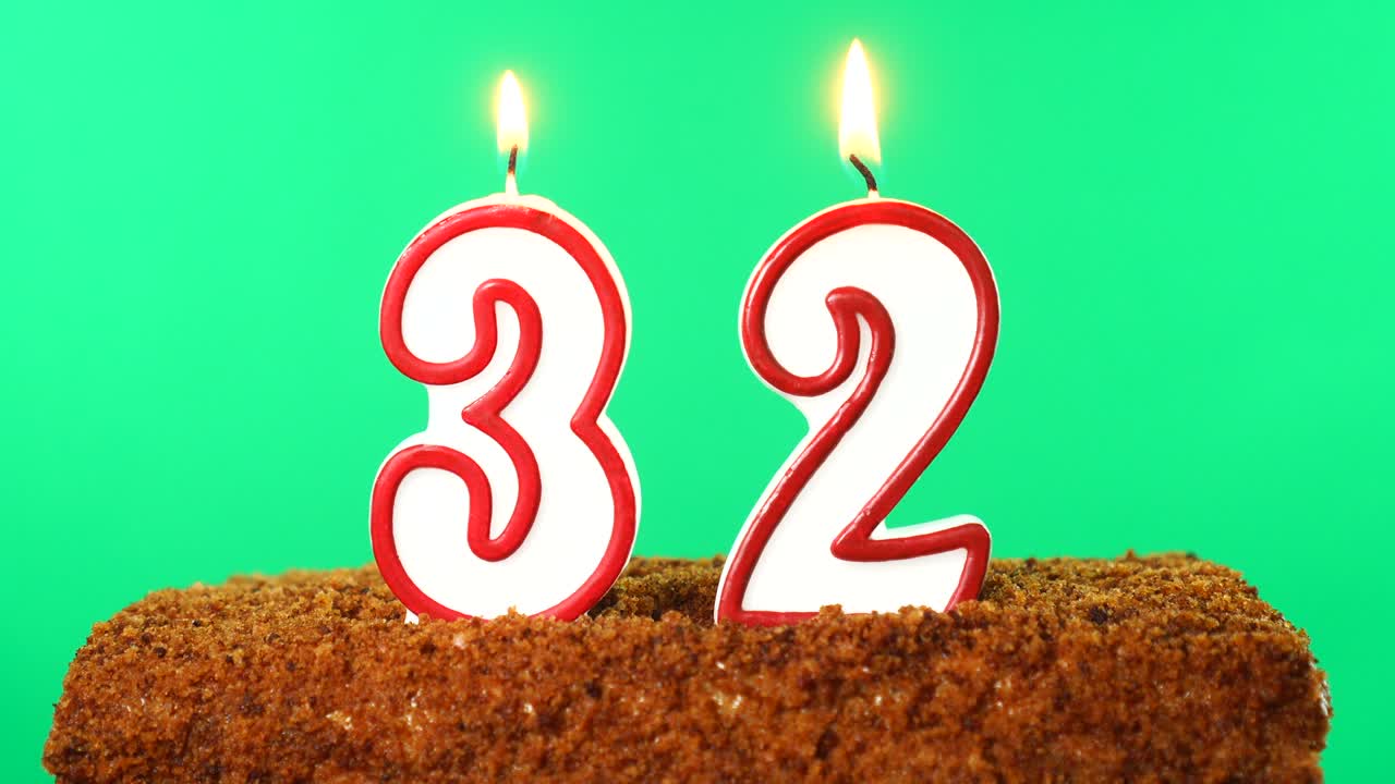 Cake with the number 32 lighted candle. Chroma key. Green Screen. Isolated