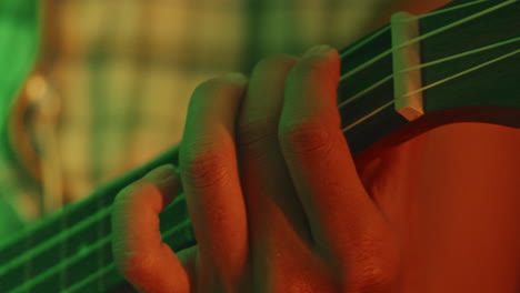 close-up of hands playing ukulele