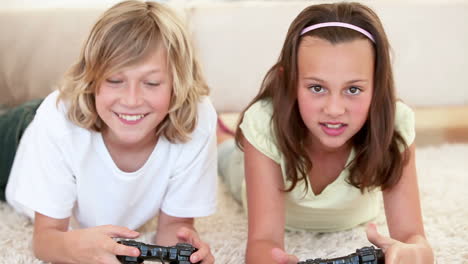 brother and sister lying while playing video games