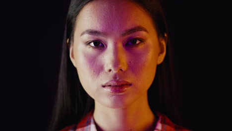close-up portrait of a woman with vibrant lighting