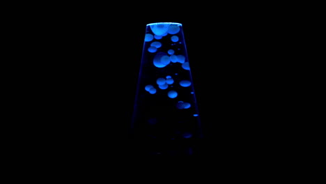 Closeup-of-blue-lit-lava-lamp,-centered-in-frame