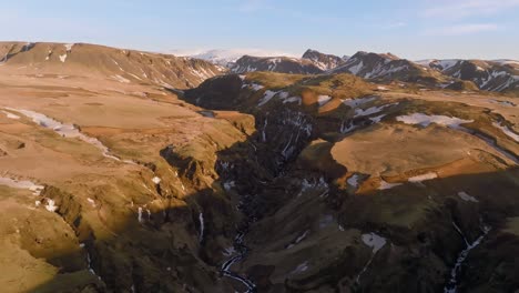 aerial forward over canyon in iceland mountain panorama during sunrise