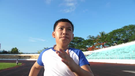 boy running at stadium