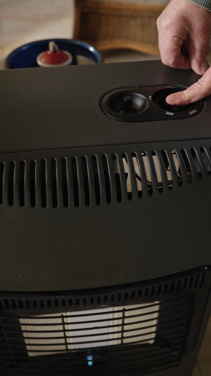 Person shows the ignition sequence on LPG heater. Ideal for tutorials and consumer guide information