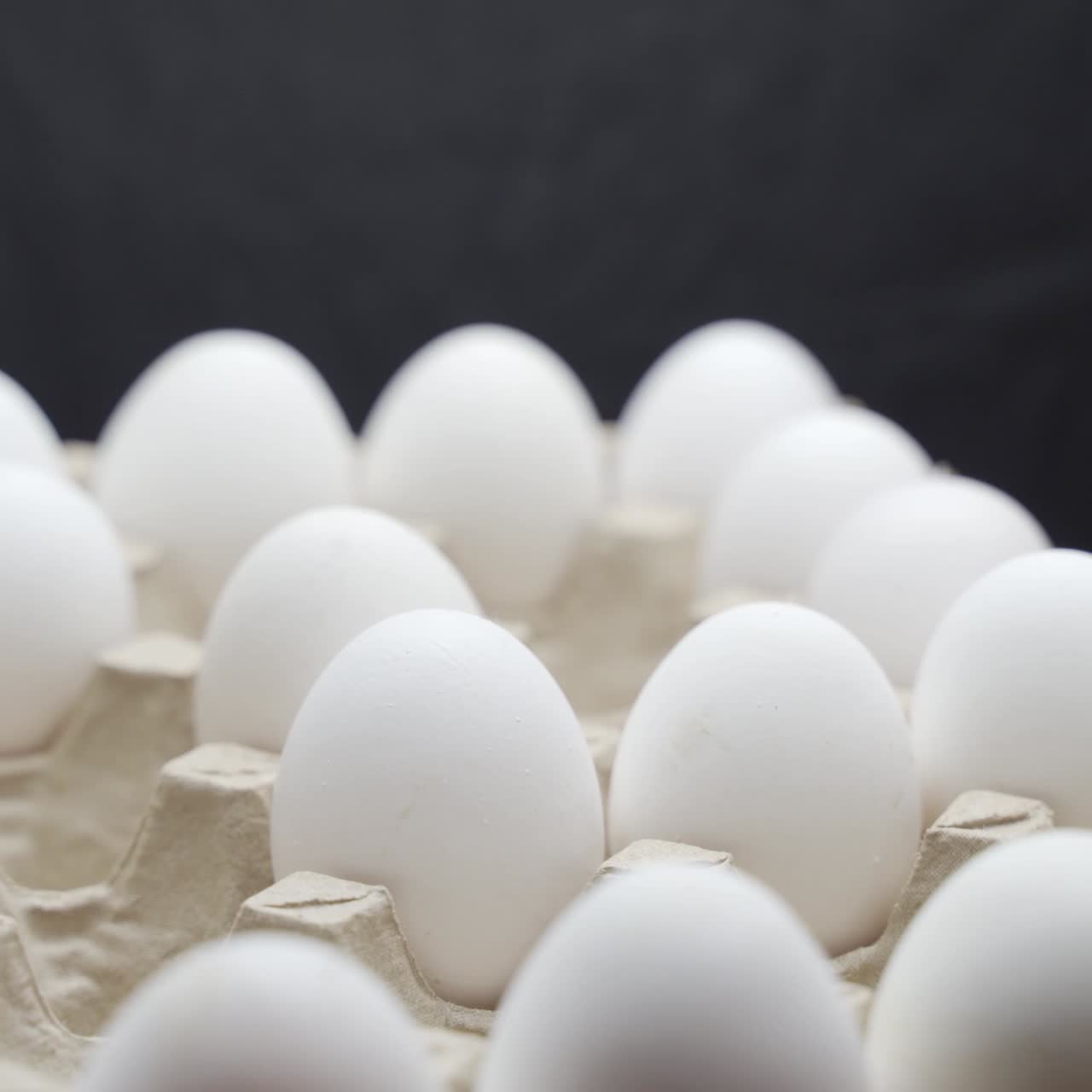 Eggs are stacked in a tray. Crates of fresh eggs at a poultry farm.
