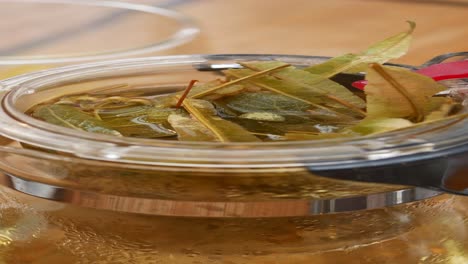 linden tea brewing in a glass teapot