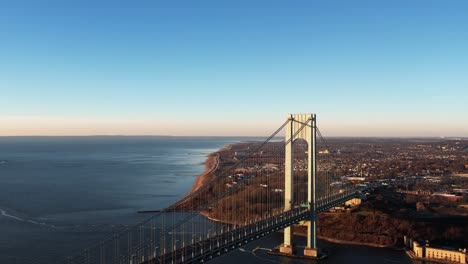 Descending-Aerial-view-in-front-of-Staten-island-and-the-Verrazzano-Narrows-bridge,-in-sunny-NY,-USA