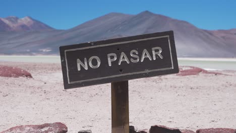 No-Trespassing-Wooden-Sign-near-a-Multicolored-Mountain-in-the-Desert