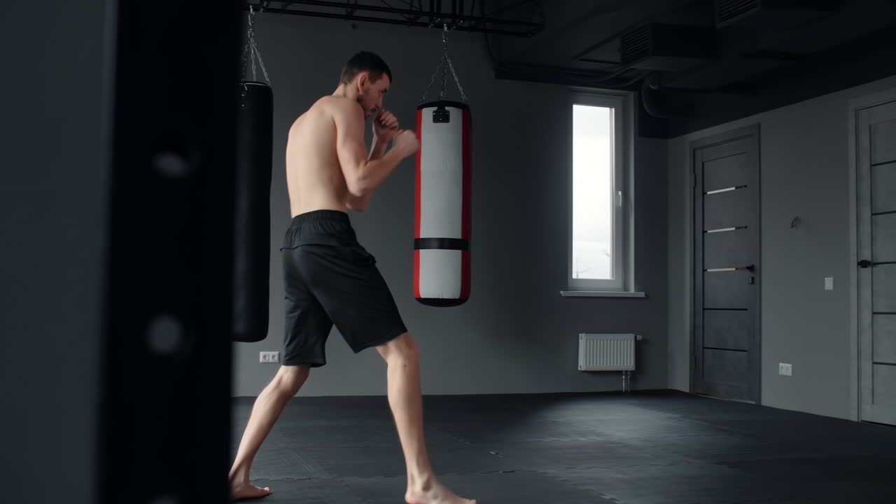 Man practicing Muay Thai in a gym