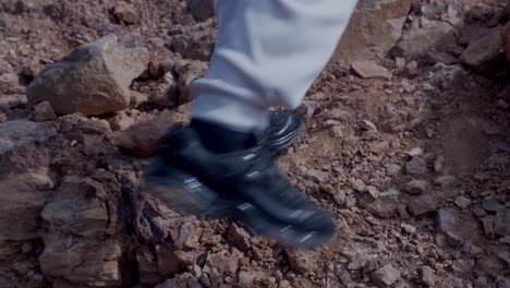 Man-walking-up-the-mountain-Rocky-terrain-of-canyon