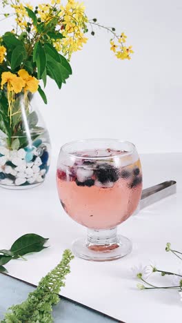 refreshing rose wine cocktail with berries and ice