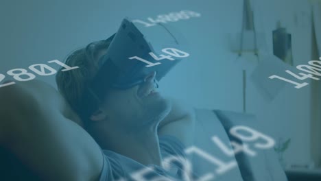 animation of numbers changing and globe of connections over man wearing vr headset in background