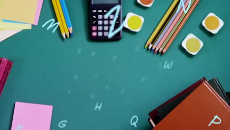 composición digital de múltiples alfabetos flotando contra el equipo estacionario de la escuela en la superficie verde