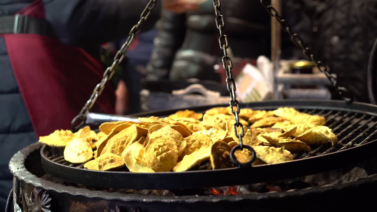 Woman sell traditional sheep cheese on christmas market from grill