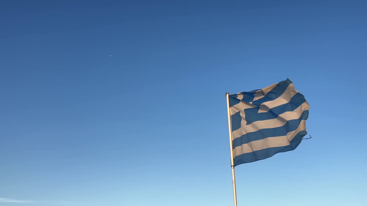 Waving Greek Flag in a Clear Blue Sky