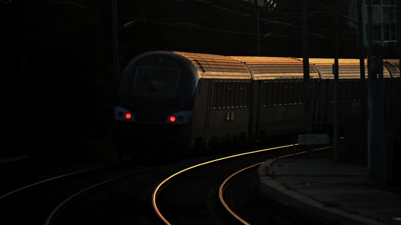 Train moving on the rails at the station at night