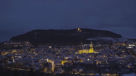a city at night illuminated by streetlights and buildings with a distant illuminated tower