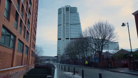 leeds city centre apartment building, car passing with snow on the ground