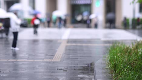 walking people on the street in marunouchi tokyo rainy day