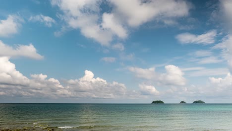 timelapse of cumulus and cirrus clouds forming above coastal beach on the tropical island of koh chang in thailand