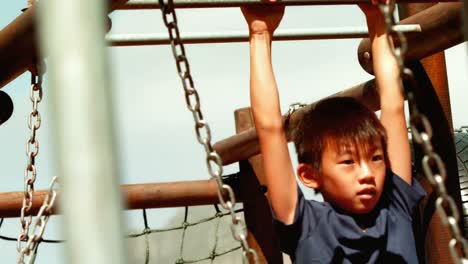 schoolboy playing on monkey rack